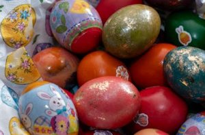 Colorful decorated eggs in woven basket
